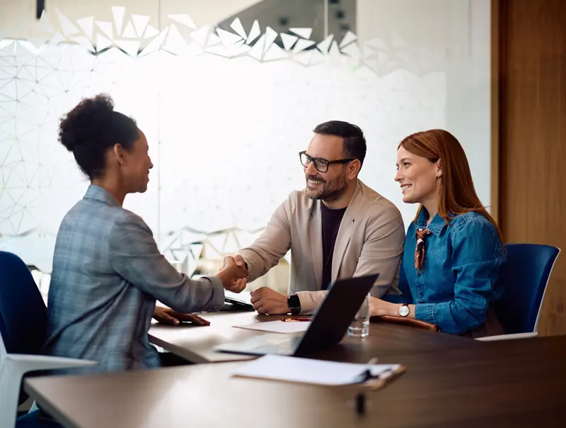 female accountant shaking the hands of her clients