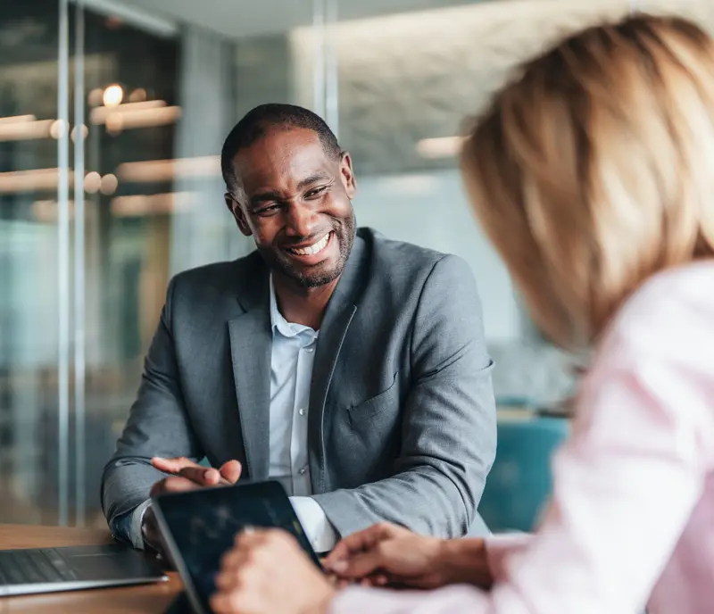 Business owner smiling and taking to an accountant