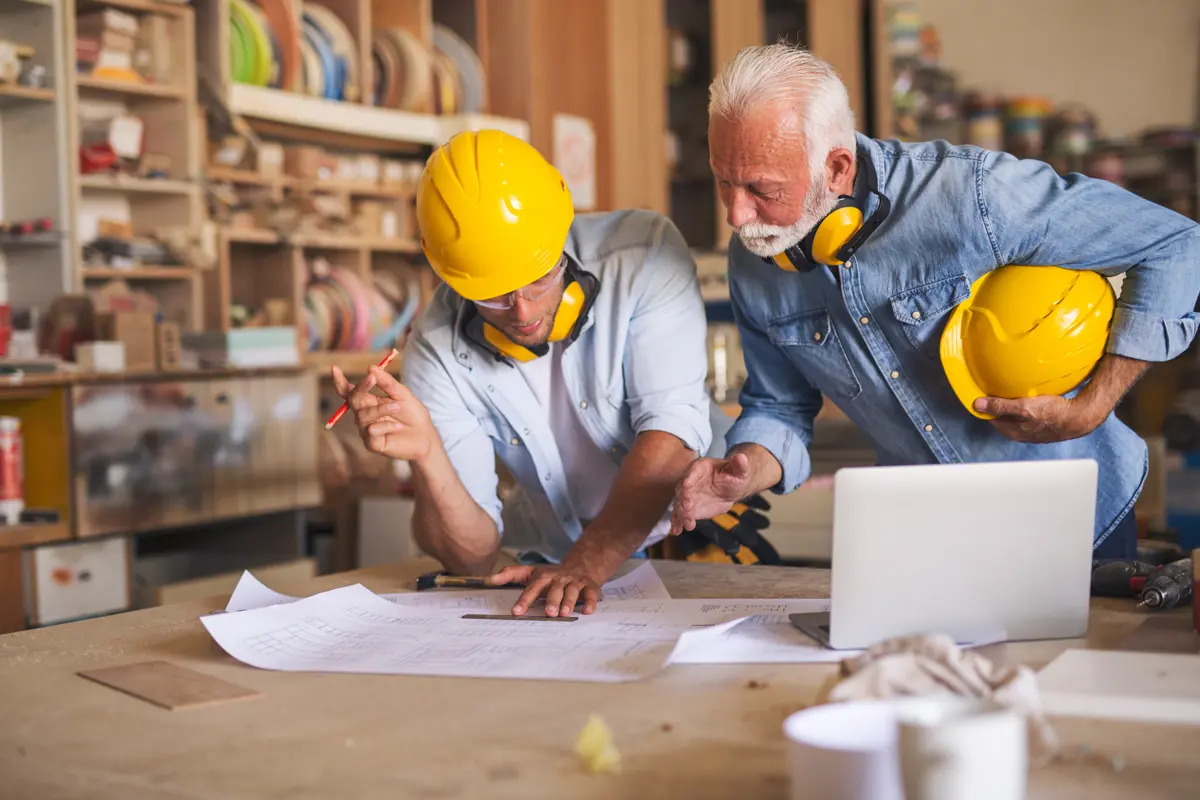 2 contractors looking over blueprints