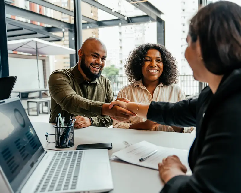 Couple shaking hands with their accountant