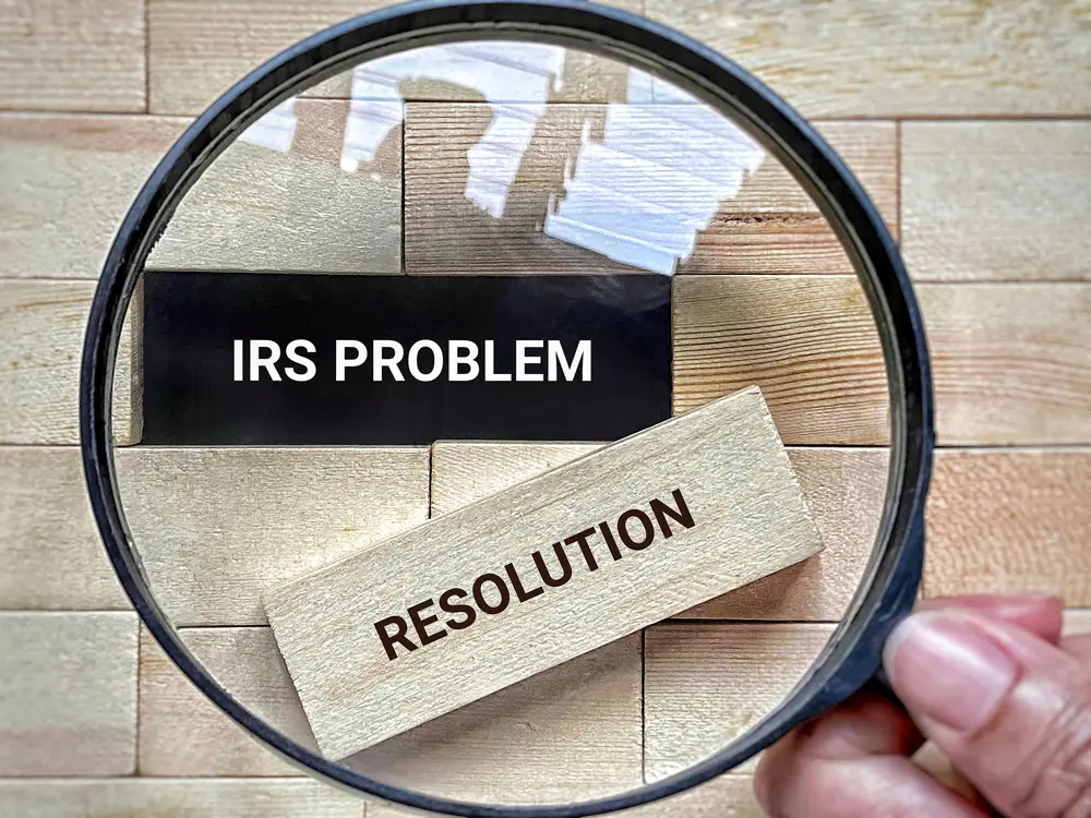 magnifying glass showing the words IRS problem