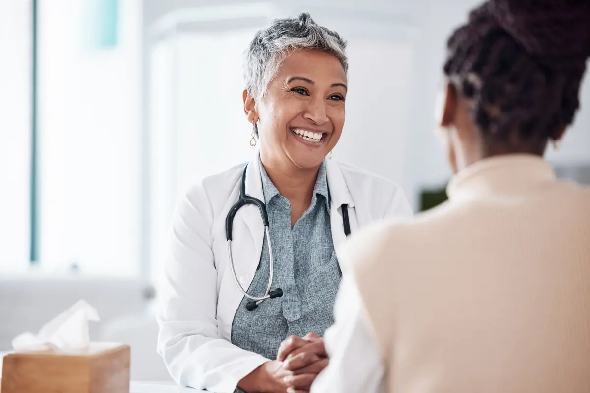 Medical Provider talking to a women and smiling